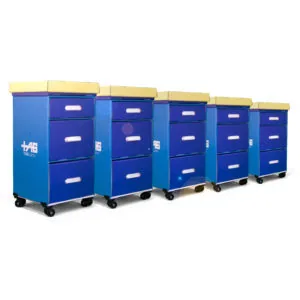 Row of five blue mobile storage carts with yellow lids and white drawer handles on caster wheels